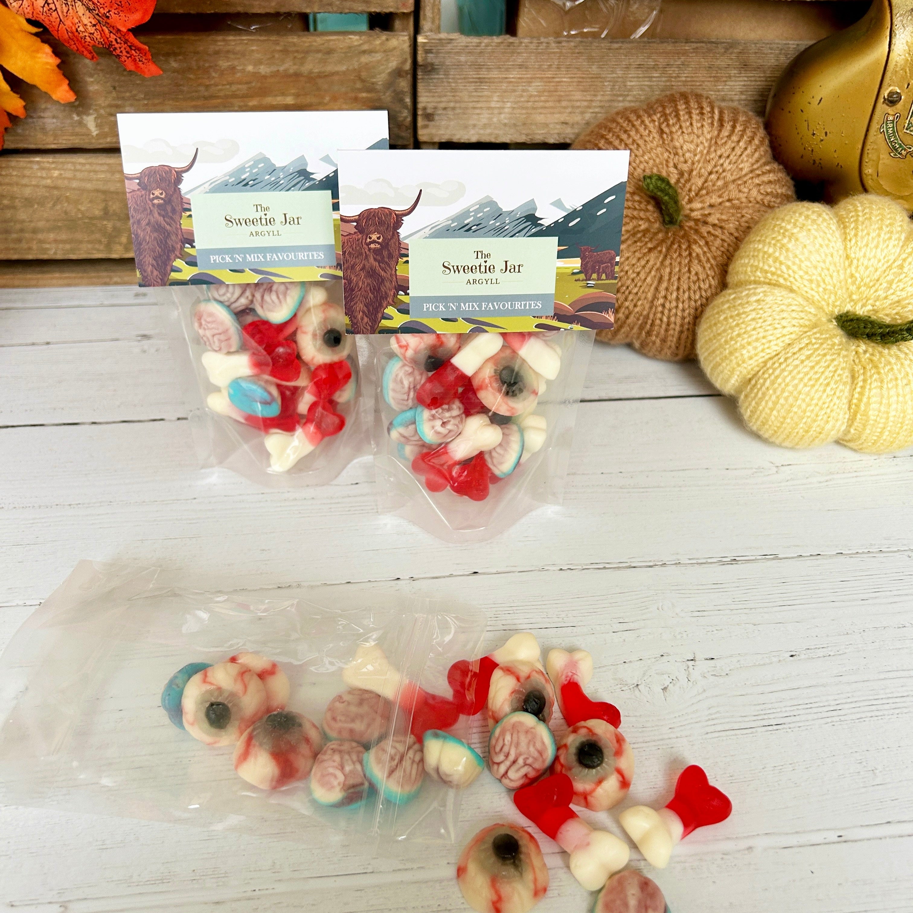 Packaged candy with autumn-themed decorations on a wooden surface